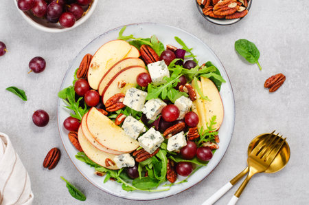 Fresh Apple Salad with Blue Cheese, Grapes, Pecans and Salad Mix, Fall Salad on Bright Background, Comfort Foodの写真素材