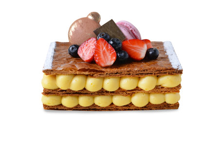 Traditional French dessert millefeuille with vanilla cream and fresh berries on White Background Isolatedの写真素材