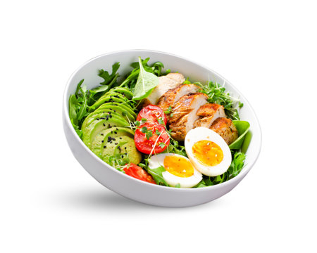 Grilled Chicken Fillet with Fresh Salad, Cherry Tomatoes, Boiled Egg and Avocado, Budha Bowl on White Background, Keto Paleo Diet Menuの写真素材