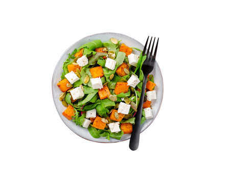 Pumpkin Salad with Arugula, Feta, and Pumpkin Seeds, Salad Mix with Roasted Pumpkin, Autumn Salad, White Isolated Backgroundの写真素材