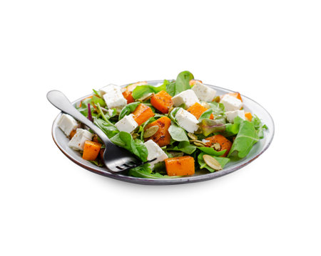 Pumpkin Salad with Arugula, Feta, and Pumpkin Seeds, Salad Mix with Roasted Pumpkin, Autumn Salad, White Isolated Backgroundの写真素材