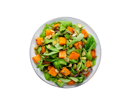 Pumpkin Salad with Arugula and Pumpkin Seeds, Salad Mix with Roasted Pumpkin, Fresh Vegan Autumn Salad, White Isolated Backgroundの写真素材