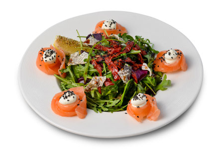 Salad with Salmon, Arugula and Sun-Dried Tomatoes, Fresh Salad on White Background Isolatedの写真素材