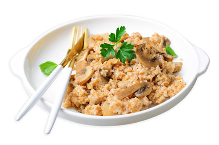 Spelt with Mushrooms on a Plate, Tasty Homemade Vegetarian Dish on White Isolated Backgroundの写真素材