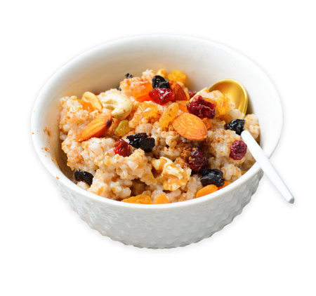 Spelt Porridge with Nuts and Dried Fruit Mix on White Isolated Backgroundの写真素材