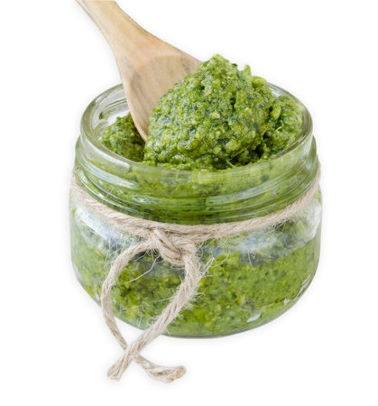 Pesto sauce with wooden spoon on White Isolated Backgroundの写真素材