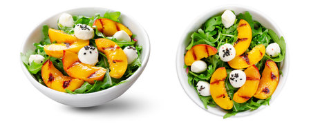 Grilled Peach Salad with Arugula and Mozzarella Cheese Pearls on White Background Isolatedの写真素材
