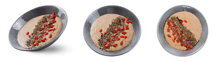 Flaxseed Porridge in a Bowl, Healthy Breakfast or Snack, Porridge Decorated with Chia Seeds and Goji Berries on White Isolated Backgroundの写真素材