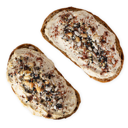 Hummus Toast with Rustic Bread, Vegetarian Snack or Breakfast on White Isolated Backgroundの写真素材