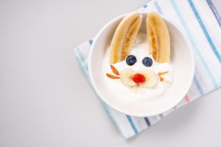 Kids Breakfast Idea, Rabbit Yogurt Bowl with Banana and Fresh Berries, Tasty Healthy Snackの写真素材