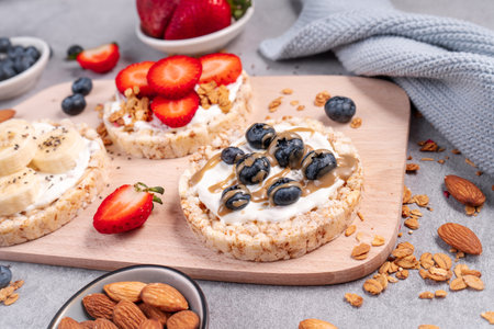 Rice Crackers Snack, Assorted Crackers Topped with Banana, Fresh Berries, Yogurt and Granola, Healthy Food, Breakfast Ideaの写真素材