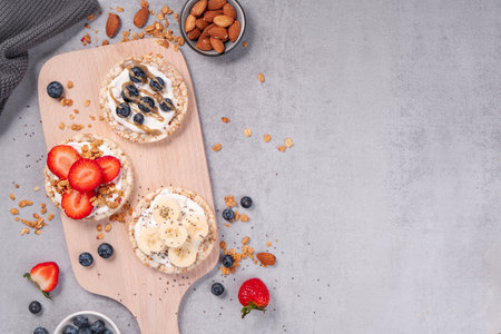 Rice Crackers Snack, Assorted Crackers Topped with Banana, Fresh Berries, Yogurt and Granola, Healthy Food, Breakfast Ideaの写真素材