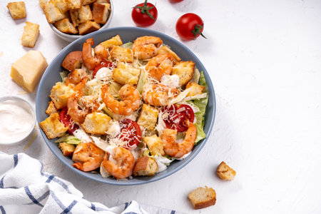 Shrimp Caesar Salad in a Bowl with Parmesan Cheese, Lettuce, Dressing and Croutonsの写真素材