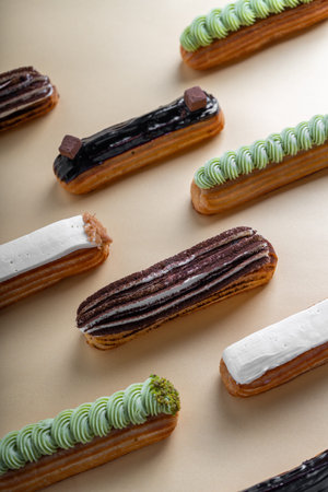 Eclairs Selection, Different Delicious Eclairs on Beige Background