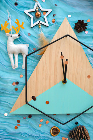 Flat lay concept with wooden clock, festive textile decor on background. Christmas countdown. New...