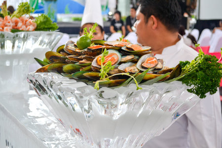 Phuket, Thailand - 08.24.2012: Raw oysters, shrimp, greens in ice plate. Fresh frozen seafood...