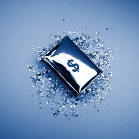 Flat lay Metallic wallet with dollar sign symbol, confetti stars. Trendy classic blue color of the year 2020 background with copy space. Business, finance, money concept clipartの写真素材