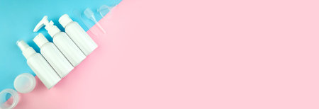 Travel size cosmetic flat lay. Minimal bottle sample set. Top view beauty banner on pink, blue...