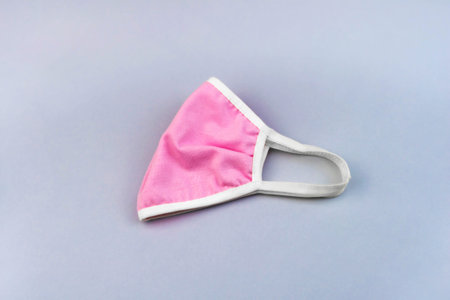 Medical protective reusable pink female mask folded in half.の写真素材