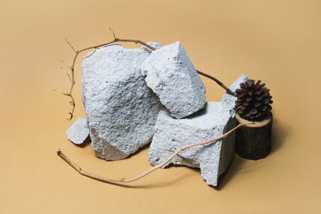 Empty stone podium composition for cosmetic products on beige background. Front view. Forest...