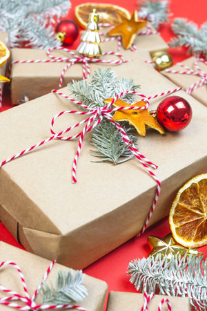 Merry christmas gift boxes still life on red background. New year holiday packaging with fir tree...