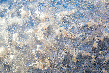 Frost on glass window. Abstract macro wallpaper. Bright pattern backdrop. Hoarfrost christmas...