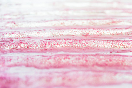 Smears of transparent cosmetic gel on pink background. Serum texture, Liquid makeup product closeup...