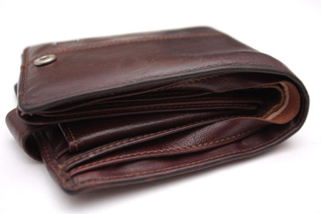 empty well-used brown leather purse isolated on white