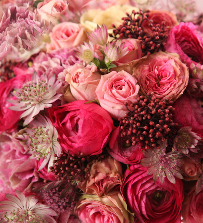 close-up of wedding bouquet with Astrantia, Skimma, Brassica, rose bush, Ranunculus asiaticus, cloves, の写真素材