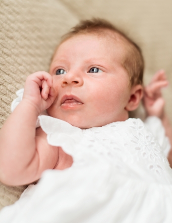Portrait of pretty baby girl in a christening dressの写真素材