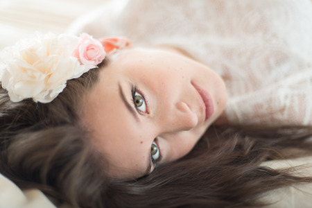 Defocused picture of a romantic woman with pink flowers の写真素材