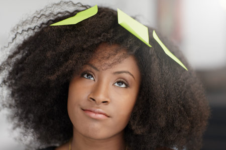 Friendly african american executive business woman brainstorming using green adhesive notes in a...