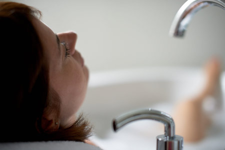 back view of a lady in her forties relaxing in a modern soaking tub