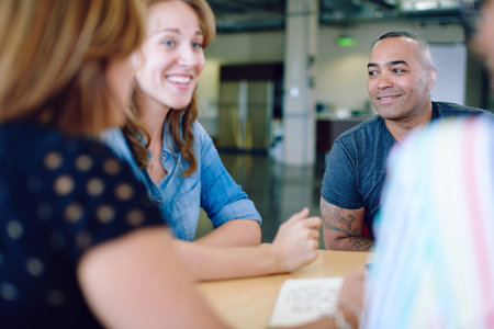 Candid picture of a business team collaborating. Filtered serie with light flares.