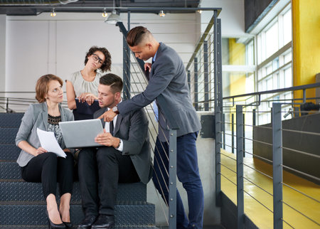 Candid photo of a corporate businesspeople group discussing strategies in professionnal indoors...