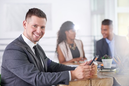 Candid photo of a corporate businesspeople group discussing strategies in professionnal indoors setting.の写真素材