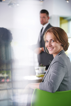Candid photo of a corporate businesspeople group discussing strategies in professionnal indoors setting.の写真素材