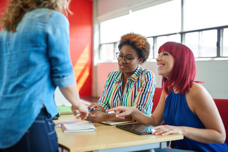 Candid picture of a business team collaborating. Filtered serie with light flares and cool tones.の写真素材