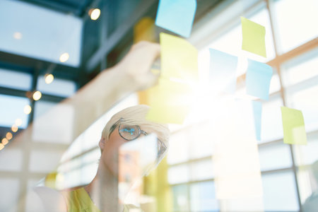 Team of young casual business people collaborating on an creative planning project using a blue and...