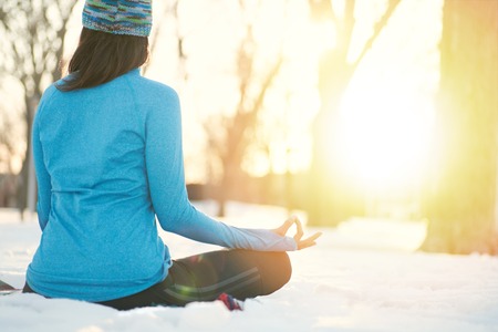 Serene lady relaxing and meditating doing yoga posesの写真素材