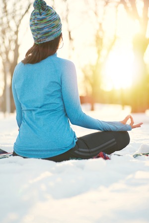 Serene lady relaxing and meditating doing yoga posesの写真素材