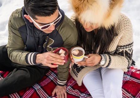 Group of millenial young adult friends enjoying wintertime and in a snow filled parkの写真素材