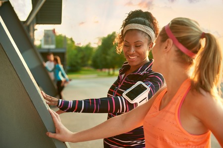 Female athletes stretching before going jogging outdoorsの写真素材