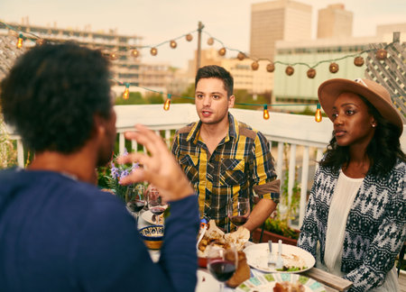 Group of diverse friends serving a balanced dinner al fresco in