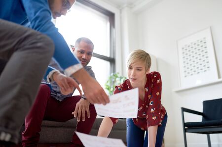 Multi-ethnic team of creative millenials collaborating on a braiの写真素材
