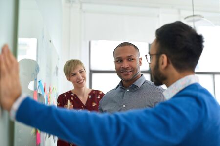 Diverse team of creative millennial coworkers in a startup brainstorming strategiesの写真素材
