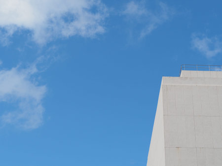 white building with a cloudy sky background