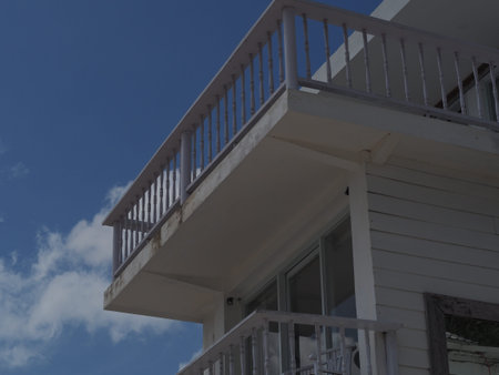 Architecture of a seaside white house with cloudy sky