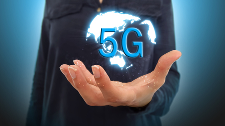 Businesswoman on a blurred background using 5G network interfaceの写真素材