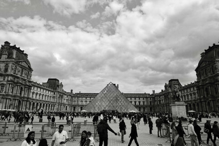 Tourists visiting the famous Louvre museum in black and white in Paris, Franceの写真素材